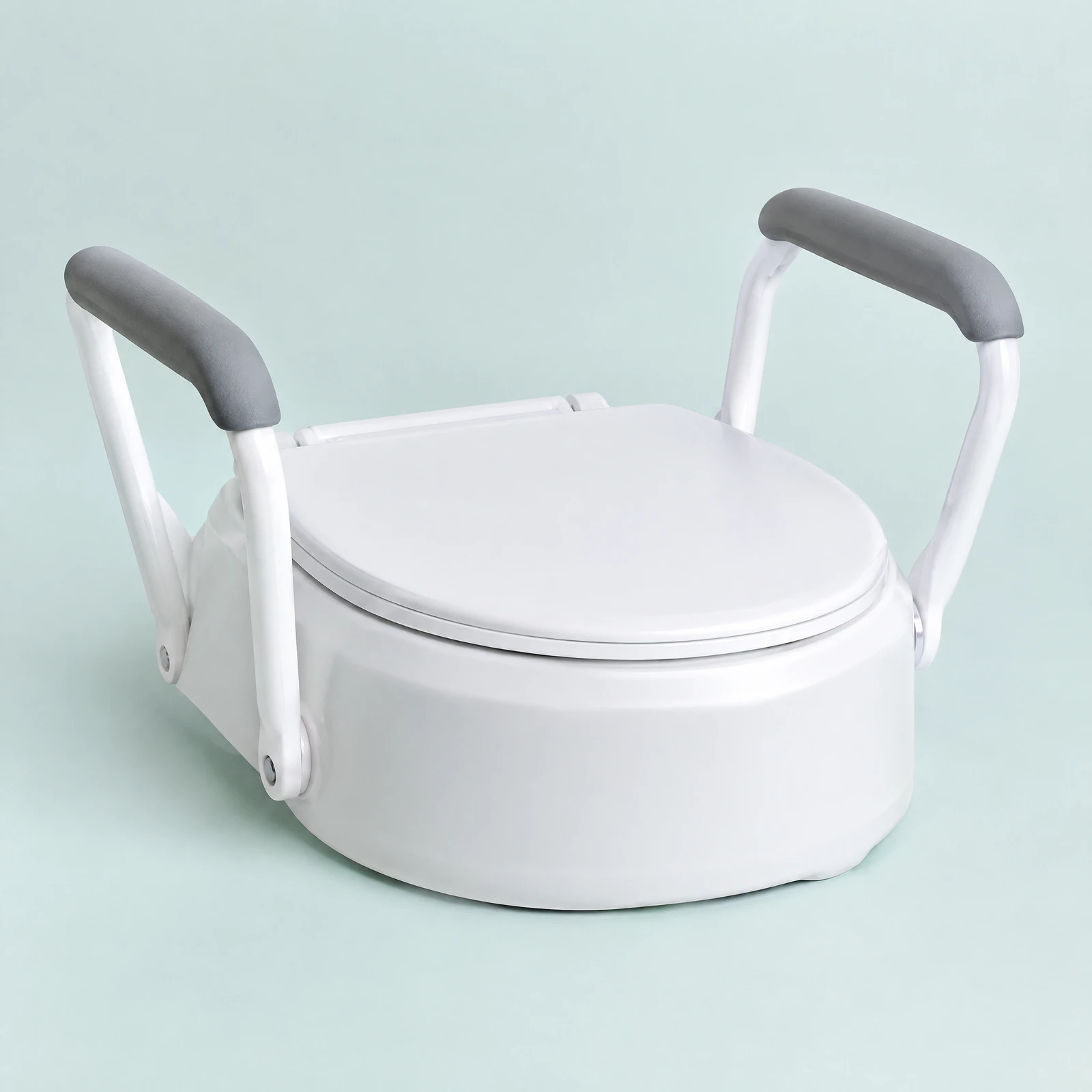 White raised toilet seat with hinged lid and two side arms with gray grips